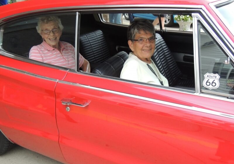 Elderly women ride in red car