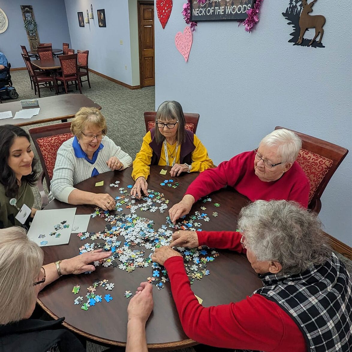 Group of elderly residents solving puzzle